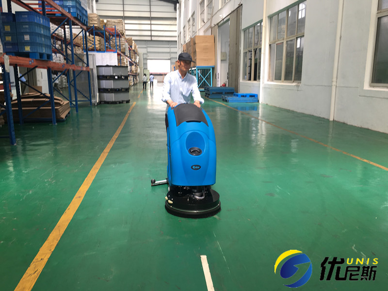 Which is more economical, a floor scrubber or manual cleaning?