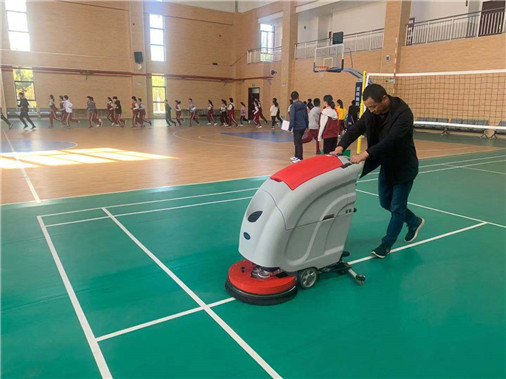Hand-push floor scrubber helps clean school gymnasium floors